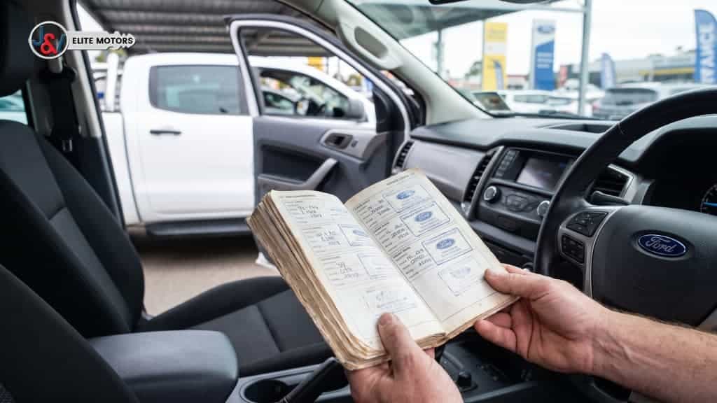 Buyer checking the service logbook of a used 2018 Ford Ranger